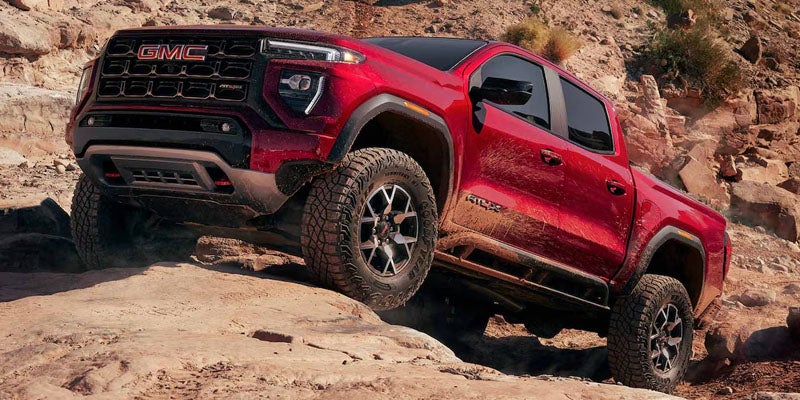 2026 GMC Canyon AT4X climbing rocky off-road terrain